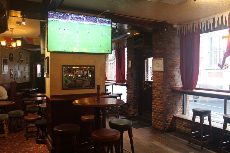 Bar area of George and Dragon English Pub showing Live Sport